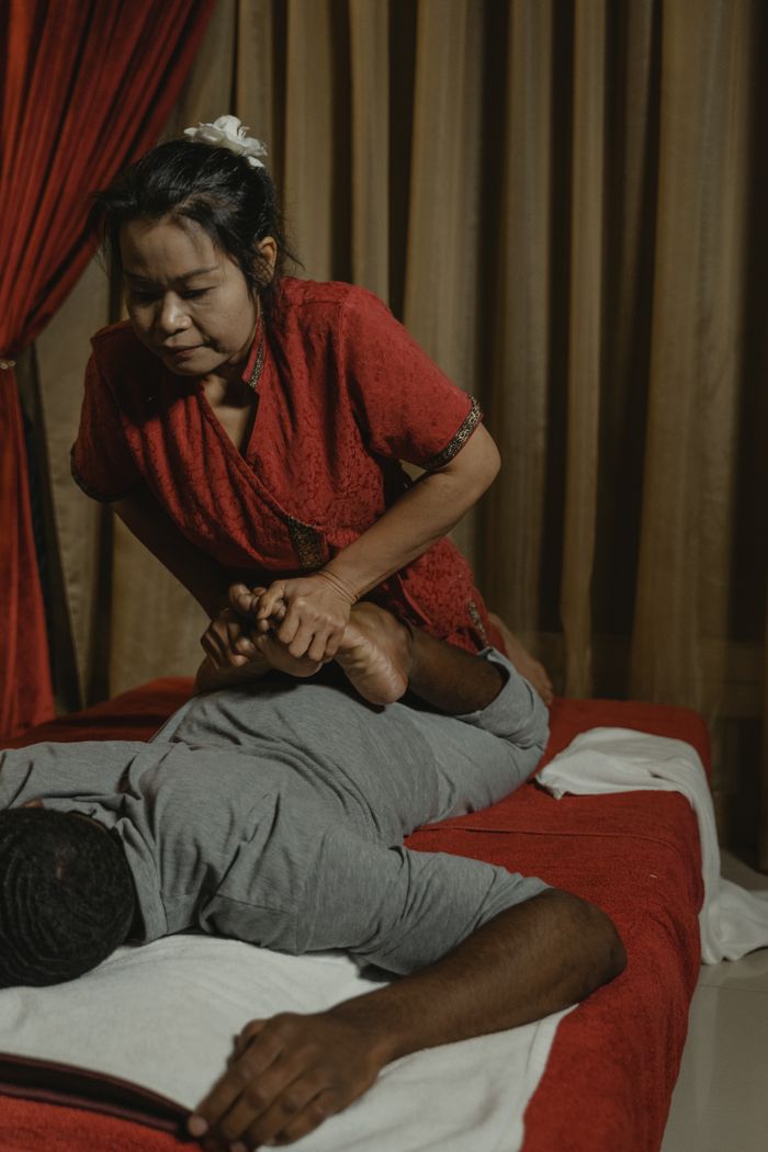 A soothing Thai massage in a tranquil room with an experienced therapist providing care.